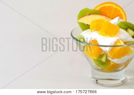 Dessert - fruit with cream, kiwi, apple and orange