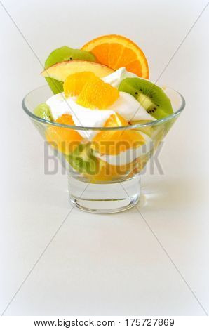 Dessert - fruit with cream, kiwi, apple and orange