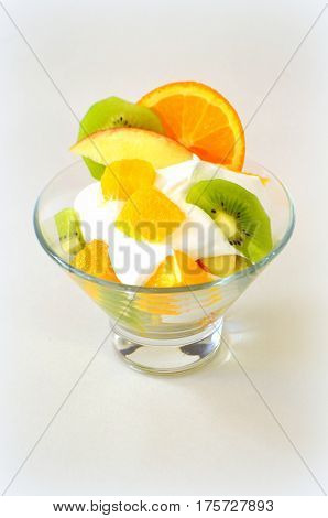 Dessert - fruit with cream, kiwi, apple and orange