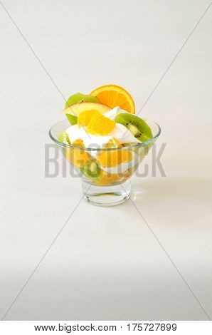 Dessert - fruit with cream, kiwi, apple and orange