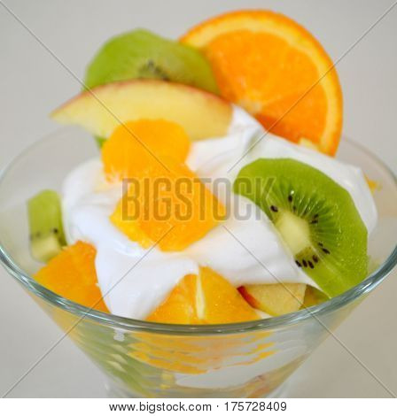 Dessert - fruit with cream, kiwi, apple and orange