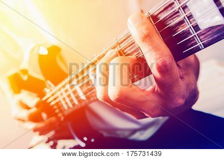 Close up shot of the man playing electric guitar