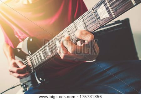 Close up shot of the man playing electric guitar