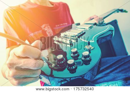 Close up shot of the man playing electric guitar