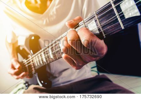 Close up shot of the man playing electric guitar