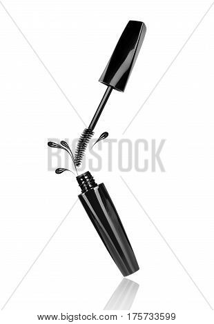 Mascara spills out of container on white background