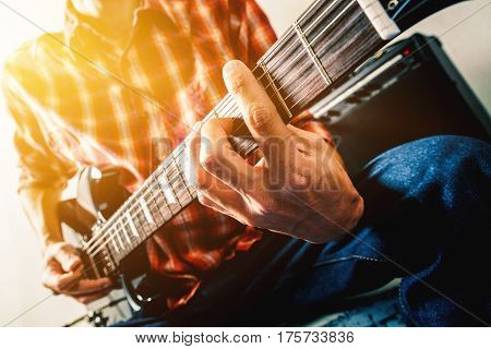 Close up shot of the man playing guitar