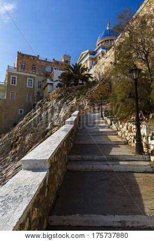 Main church of Ermoupoli on Syros island in Greece as seen from a walkway to the town beach.