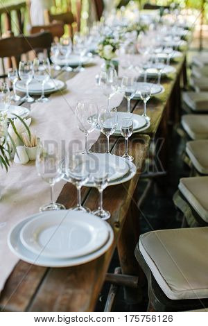 Glasses on the festive table setting. Wedding table decor. Table setting in classic style, setout.