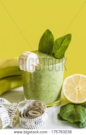 Fresh and healthy green smoothie with spinach,banana and lemon