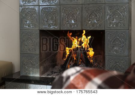 Interior room with fireplace and fire in winter time