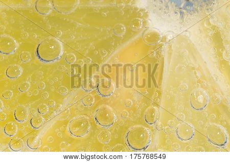 lemon slice in bubble soda water close-up