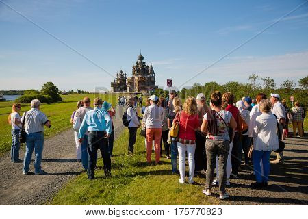 ISLAND OF KIZHI, RUSSIA - CIRCA JUNE: Tourists visiting the historical sights on the famous island of Kizhi, north of Russia. Architectural ensemble of Kizhi is on the UNESCO World Heritage List