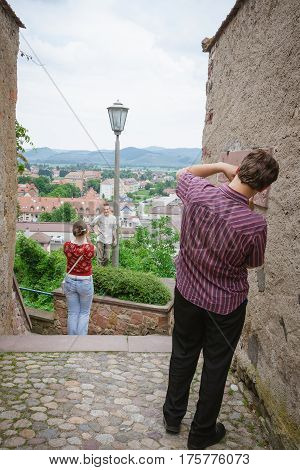 BREISACH GERMANY - JUNE 14 2010: tourists photographing each other in the old town
