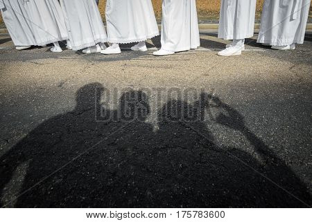 Tourist shadows taking photos and enjoying easter traditional procession in bercianos de aliste brotherhood, zamora, Spain