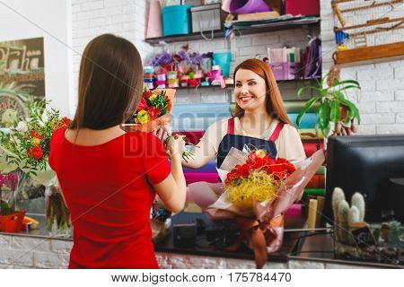 attractive young girl working in a flower shop