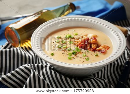 Delicious cream soup with bacon on table