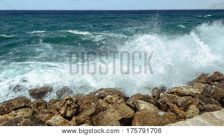 Big wave the azure sea is divided into bryzkami on the rocky shore