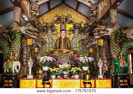 Statue of Big Golden Sitting Buddha in Van Hanh pagoda monastery in Dalat, Vietnam