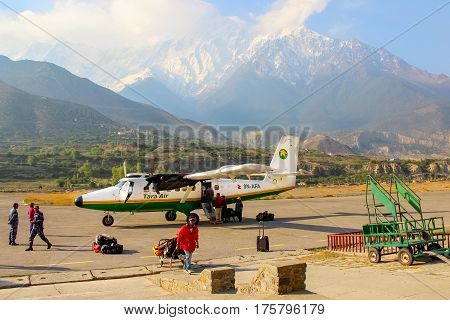Nepal Himalayas Jomsom Airport - April 2015: Tourists and local people flew on a small plane to the airport in the mountains of Nepal. Jomsom track.