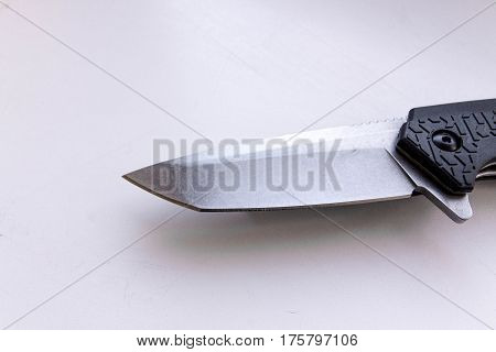 Blade of a knife on a gray background.