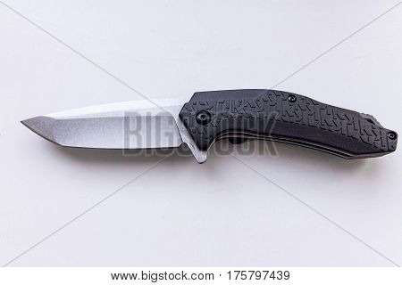 Pocket knife on a gray background. Top view.