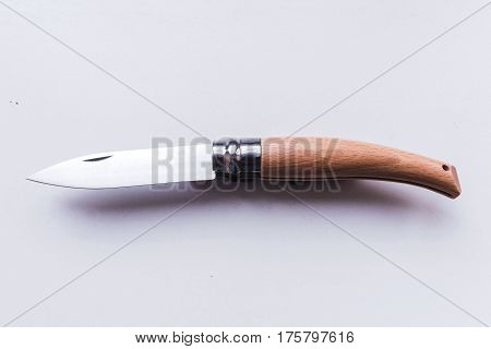 Penknife. Knife for harvesting grapes. Agriculture. Gray background.