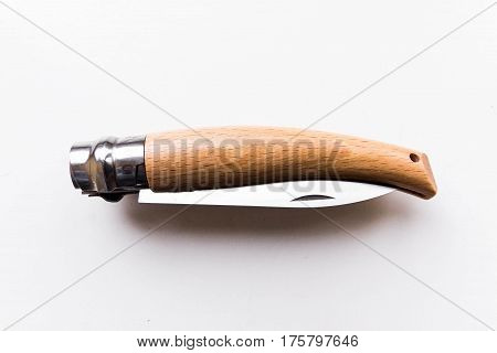 Penknife folded. Gray background. Knife with a unique mechanism.