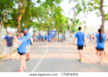 Blurred people exercise in pub lic park while sunrise