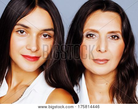 cute pretty teen daughter with mature mother hugging, fashion style brunette makeup close up, real happy family