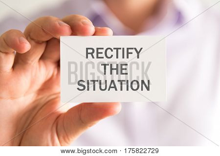 Businessman Holding A Card With Rectify The Situation Message