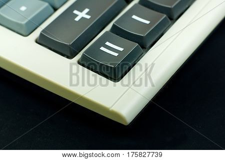 Financial Calculator on black background focus on qual sign buttons