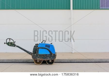 Asphalting paver during road roller at work on the road construction