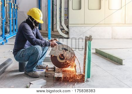 Construction worker working on cutting a metal and steel with compound mitre saw with sharp circular blade