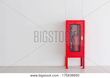 Fire Extinguisher in red Cabinet on Wall for fire protection in factory manufacturing with copy space.