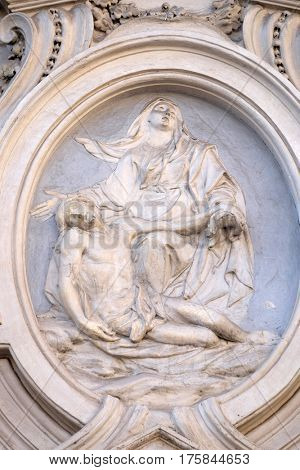ROME, ITALY - SEPTEMBER 02: Our Lady of Sorrows, bass relief on the facade of Sant Andrea de Urso church in Rome, Italy  on September 02, 2016.