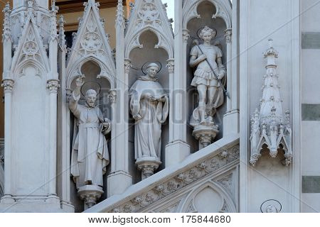 ROME, ITALY - SEPTEMBER 02: Statues of St. Francis Xavier, Dominic of Guzman and Michael Archangel on the facade of Sacro Cuore del Suffragio church in Rome, Italy  on September 02, 2016.
