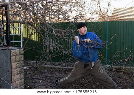 Man in working clothes working in the garden