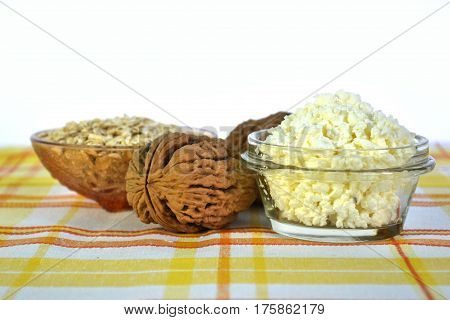 Cottage cheese in a brown bowl with oatmeal and jam