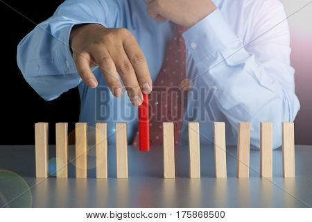 Businessman Hand Pick One Of Wood Block From Many Wood Block In Row, Metaphor To Business Concept In