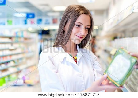 Pharmacist And Health Care Worker In Phamarcy With Medicine And