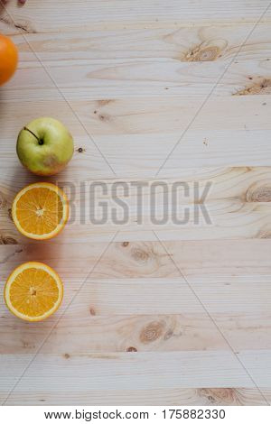 Fresh red and green apple, orange on wooden decks. Fruit, citrus table. Color