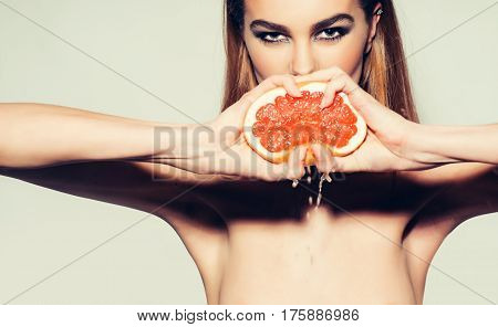 Pretty Girl Squeezing Juice From Fresh Orange Grapefruit