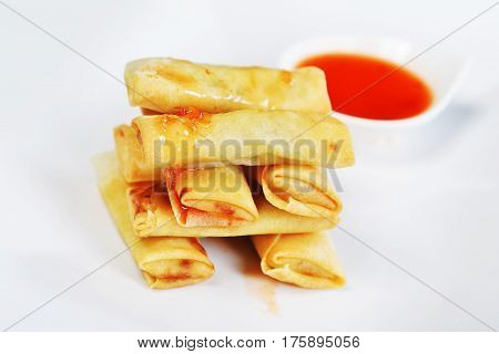 tasty rolls of pancakes with stuffing on plate