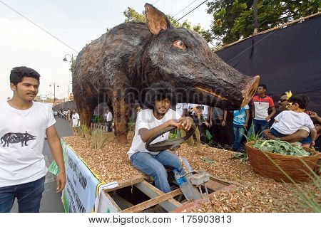 PANJIM, INDIA - FEB 25, 2017: Agricultural platform with a figure of a wild boar driving on street during the traditional Goa carnival on February 25, 2017. Carnaval is celebrated in Goa since 18th century