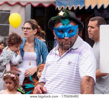 Man In Blue Mask Stands And Looks At сarnival Parade