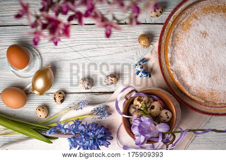 German Easter cake, eggs, flowers, ribbons on the table copy space horizontal