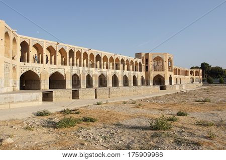 ISFAHAN, IRAN - OCTOBER 11, 2016: Khaju bridge crossing parched Zayandehrud river on October 11, 2016 in Isfahan, Iran