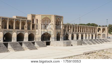 ISFAHAN, IRAN - OCTOBER 11, 2016: Khaju bridge crossing parched Zayandehrud river on October 11, 2016 in Isfahan, Iran