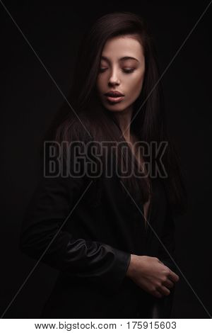 portrait young elegant woman wearind black jacket. Fashion studio shot.